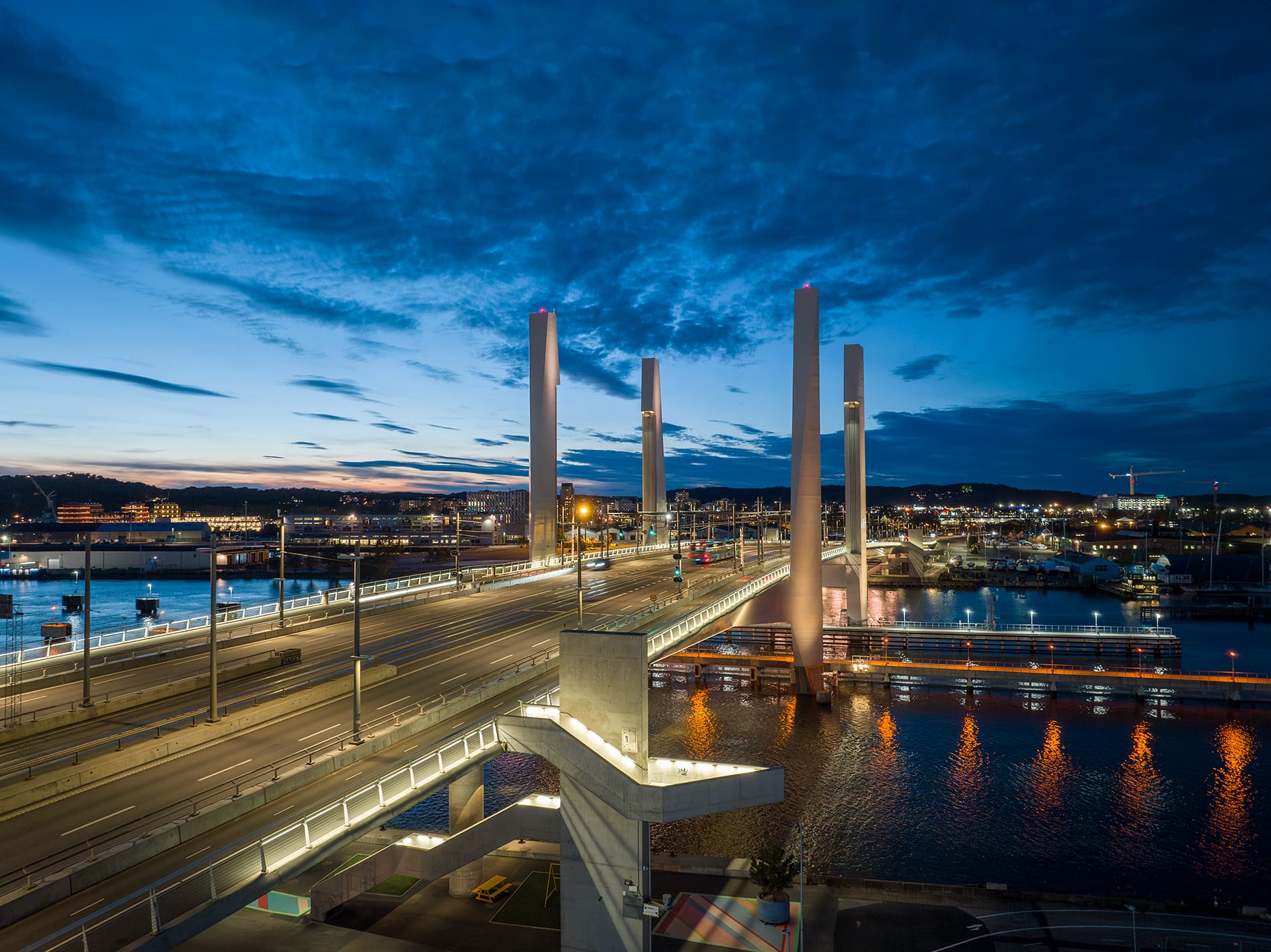 Blue-hour road and bridge lit by real luminaires