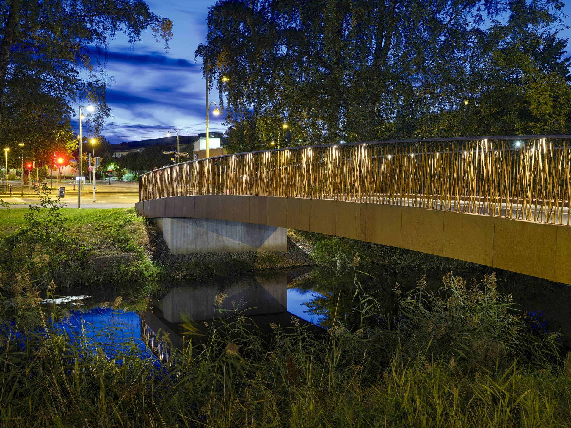 Pedestrian bridge at blue hour with warm integrated lighting